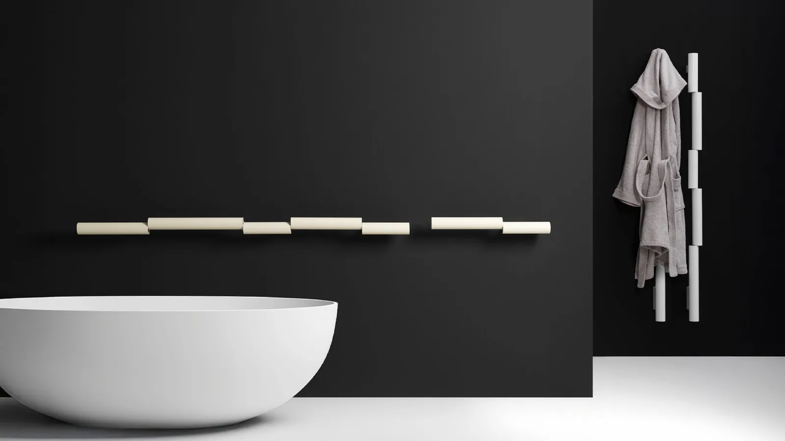 Antrax IT Pypeline Designheizkörper in einem schwarzen Badezimmer mit freistehender Badewanne